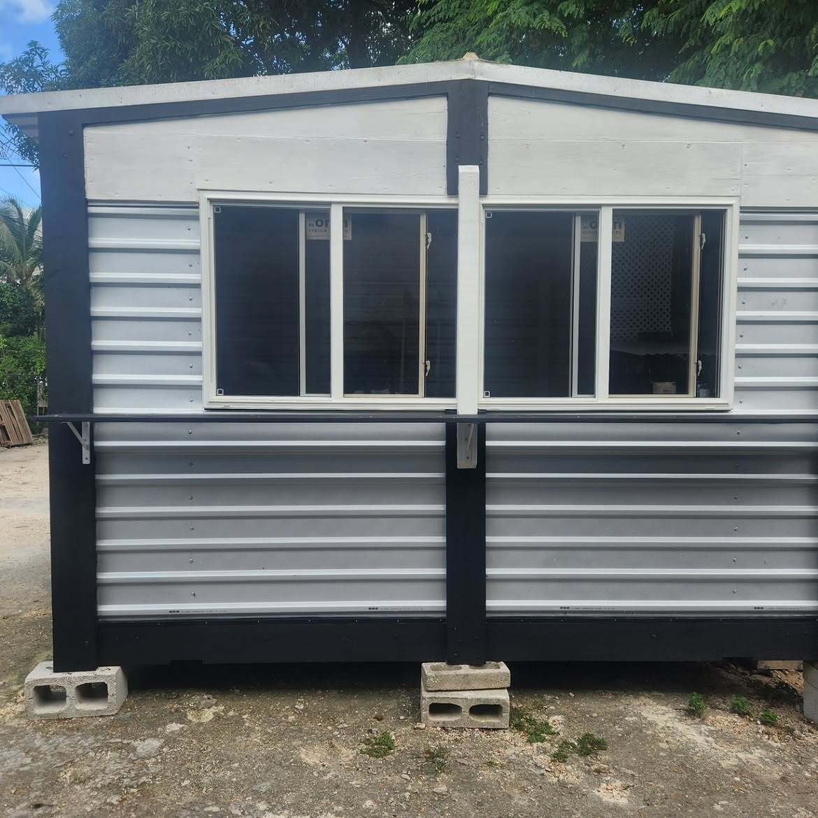 Canteen with serving windows and a counter, in Six Roads