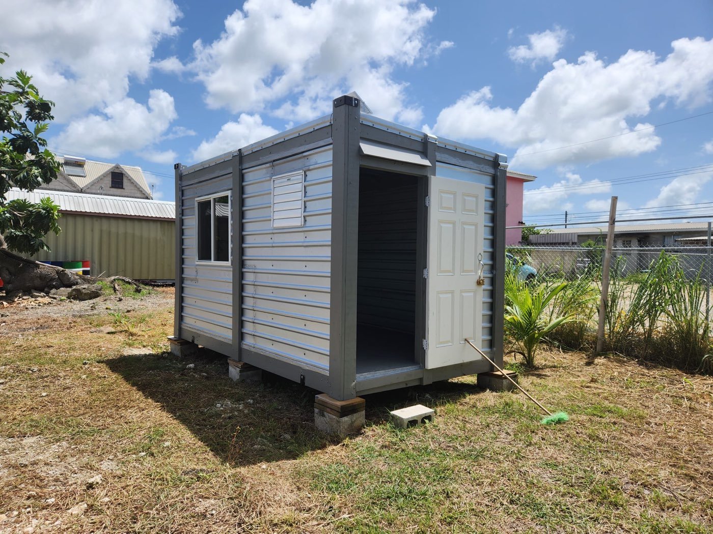 Grey-framed storage unit in a yard