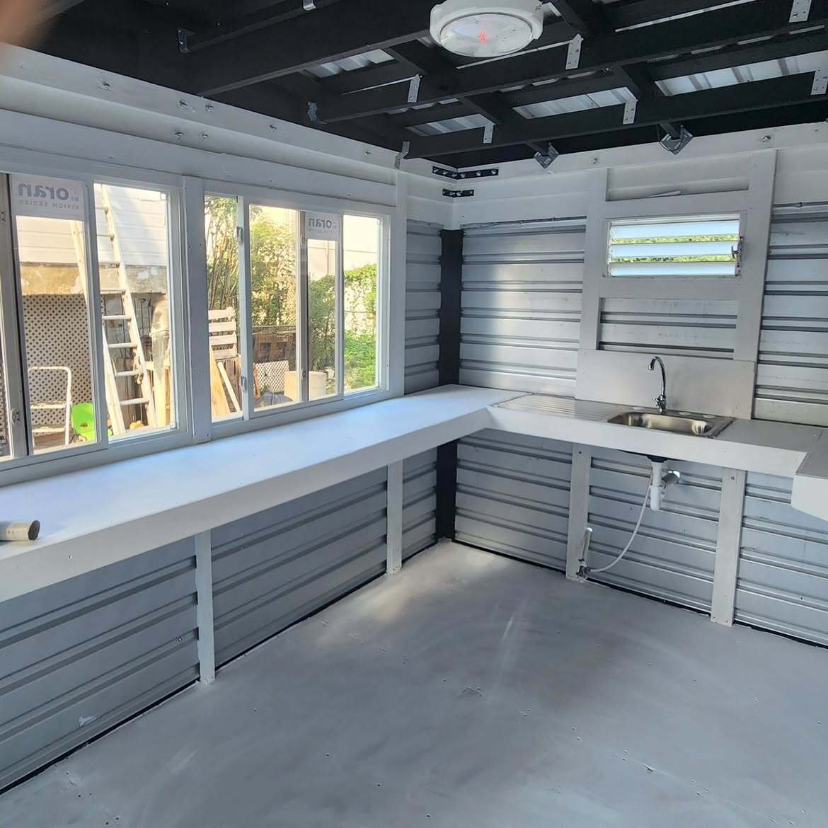 Interior with a counter along the windows and a sink