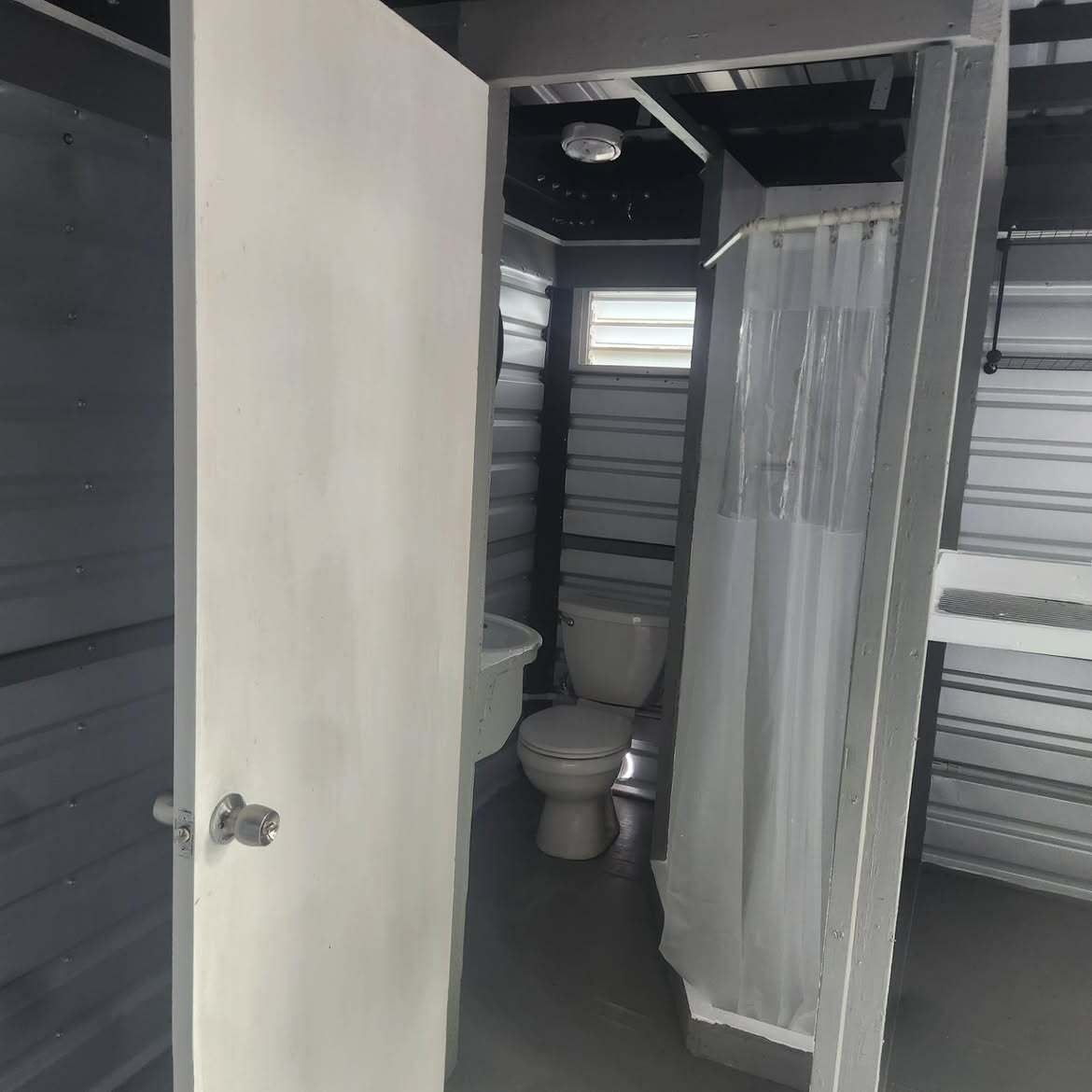 Bathroom fit-out with a toilet and shower curtain