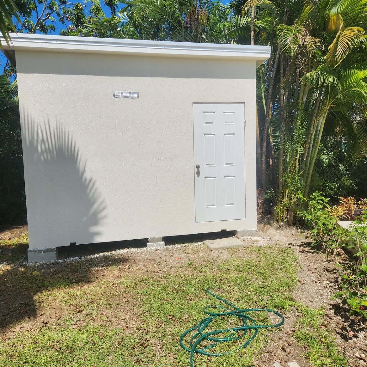 Cream storage shed with a white door
